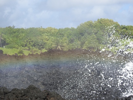 Faint rainbow from crashing waves at Waiʻanapanapa State Park